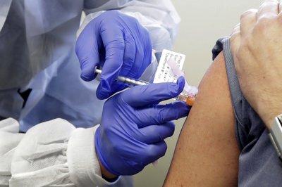 Una persona es inyectada en la primera etapa de un ensayo clínico para una posible vacuna contra el COVID-19, en Seattle.