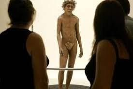 Visitantes observan la representación de un hombre de Neandertal,