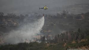 Helicóptero lanza agua hacia un foco de fuego